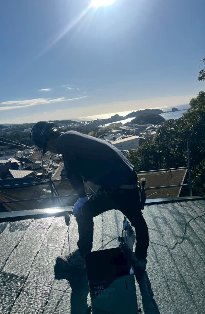 屋根の上での塗装作業風景